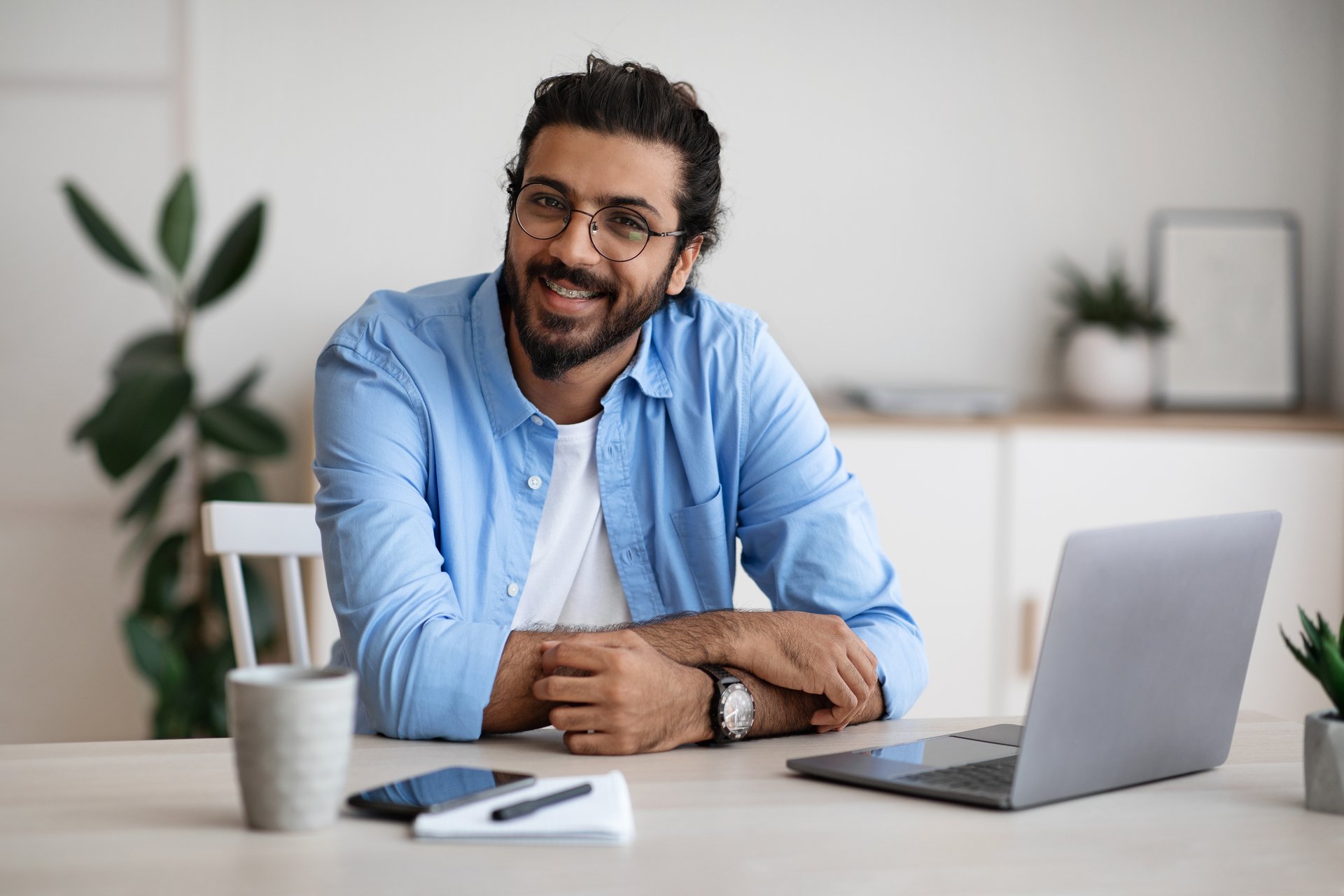 freelance-career-handsome-indian-guy-sitting-at-la-7GSJQSC.jpg