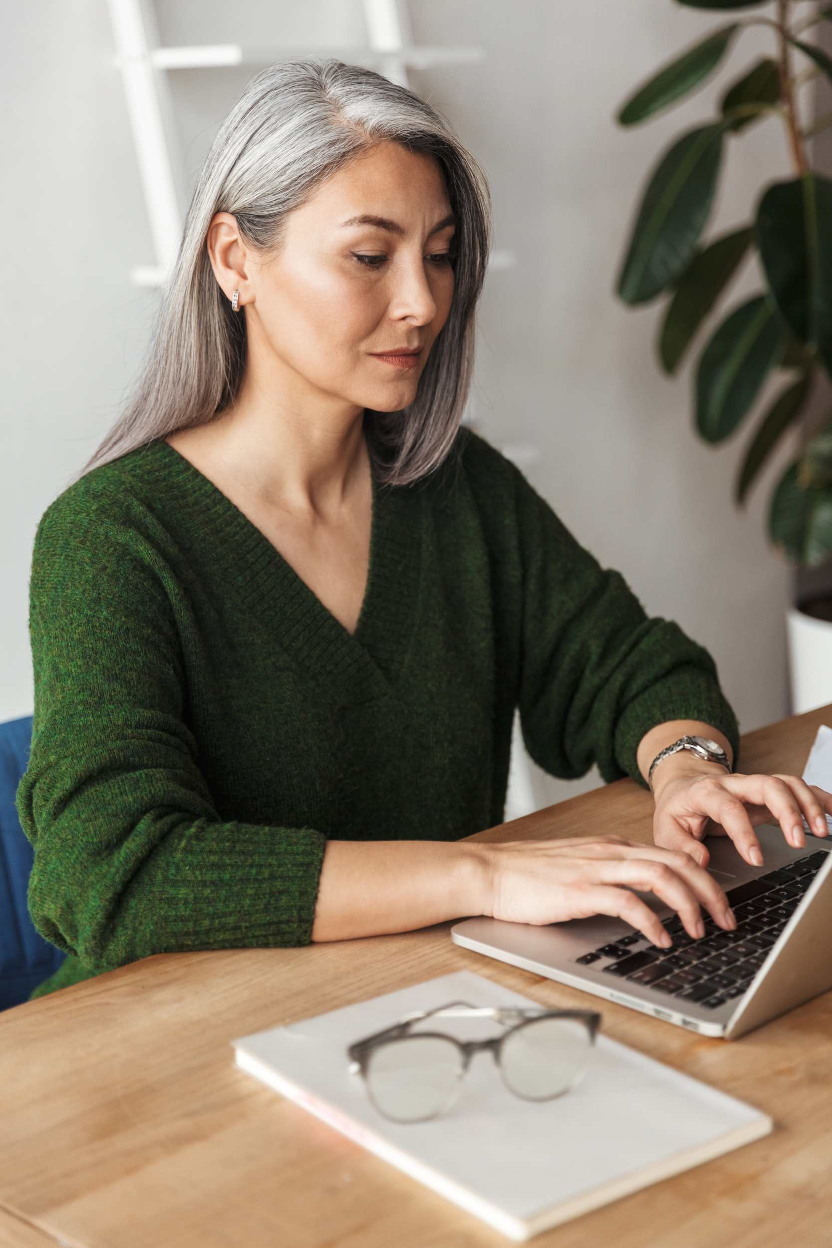 photo-of-gray-haired-focused-businesswoman-typing-MJKPXEZ.jpg